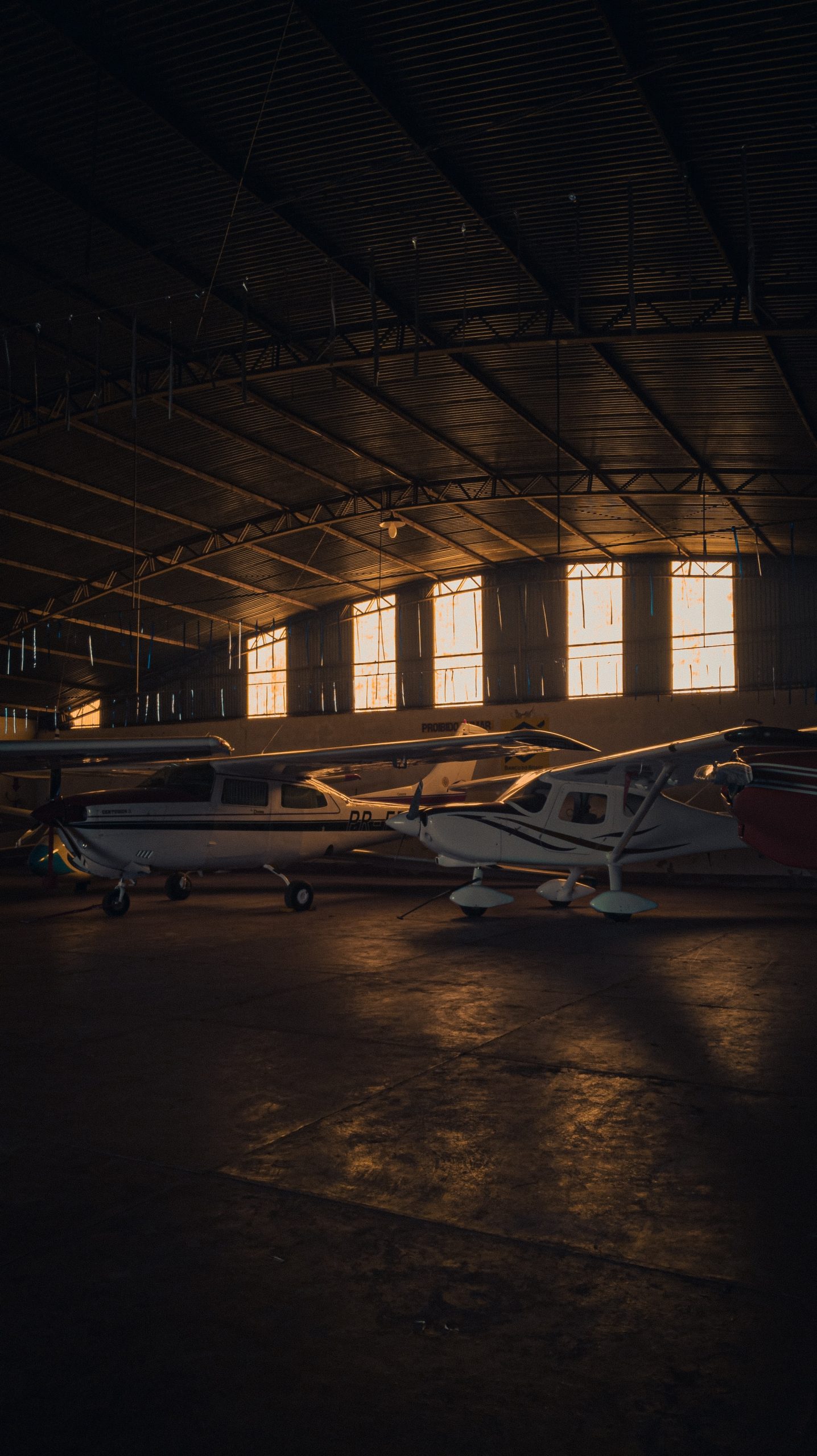 White and Red Airplanes in a Building